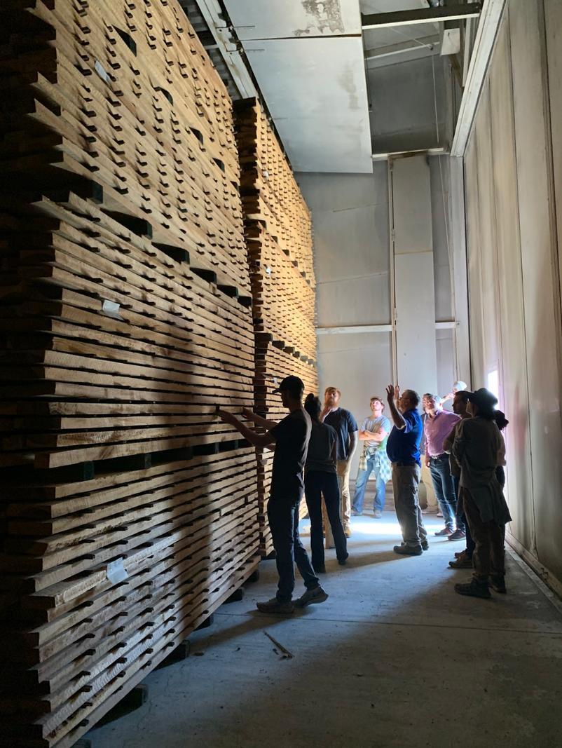 Wood Science and Technology students looking at stacks of lumber.